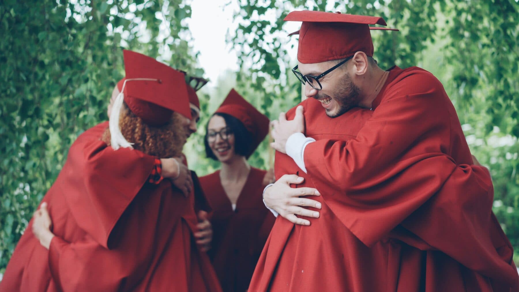 Graduates celebrating with a hug